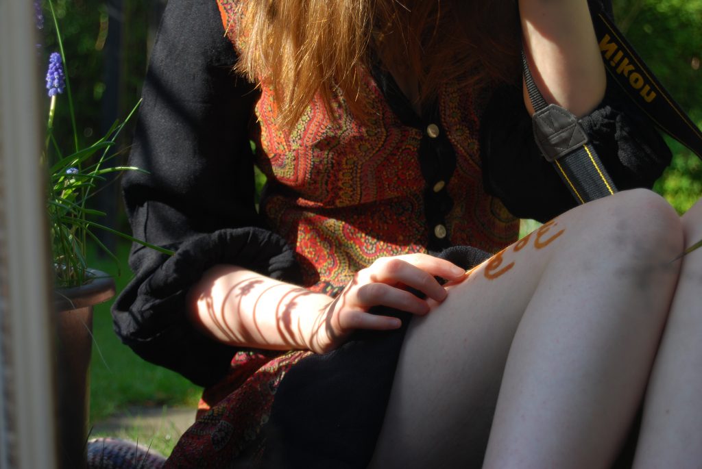 Decorative photo featuring soft sunlight and a thin white woman wearing a 1970s dress.