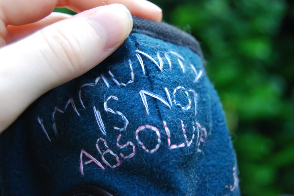 A close up photograph of words on the mask.
