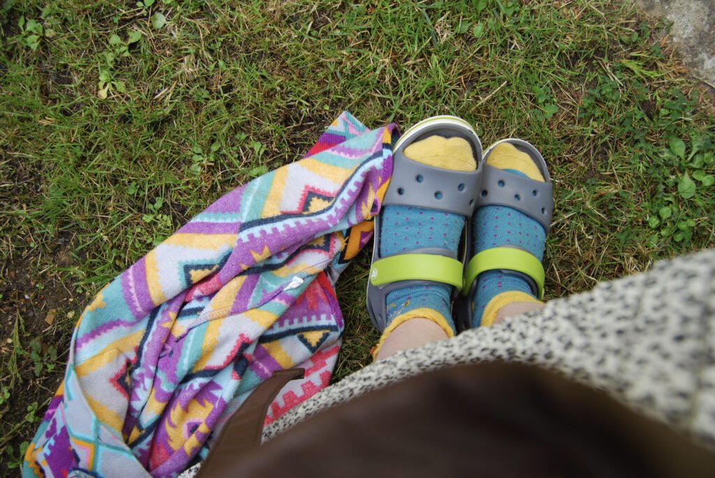 Sakara's feet with her shirt bundled up on the floor next to them, picture taken from above.