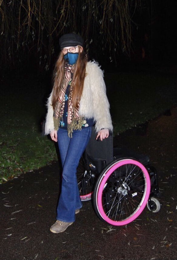 Image: Sakara stands by her wheelchair.