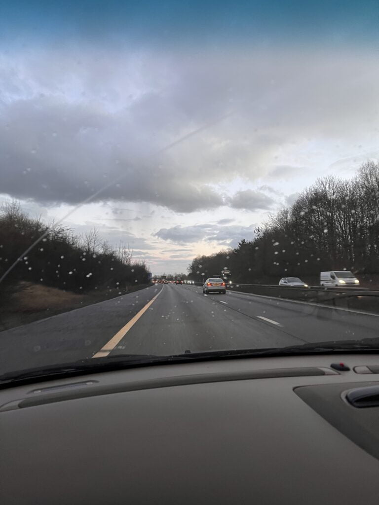Road ahead shown from the inside of a car.