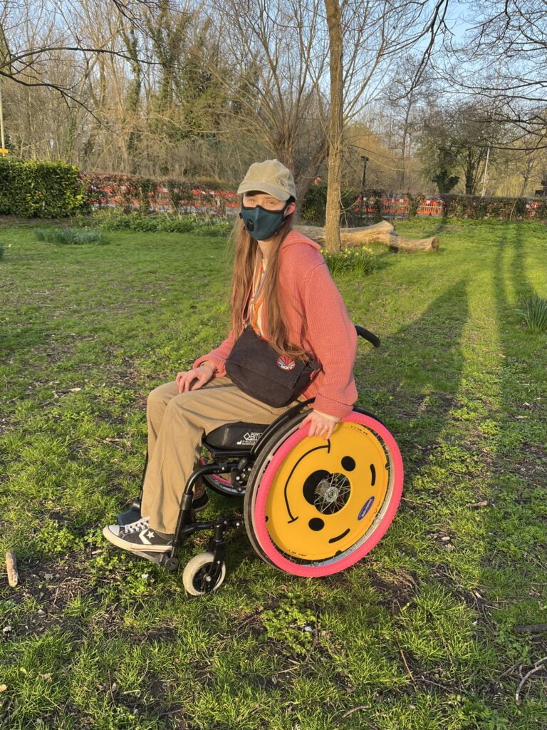 Sakara smiles, one hand on her wheel.